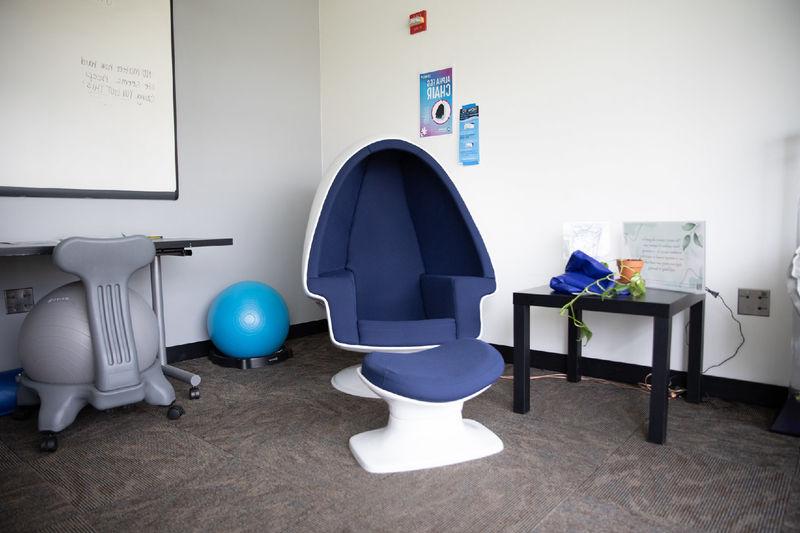 An egg-shaped chair and medicine balls sit in a quiet place.